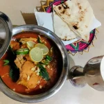 chicken curry in a silver pot